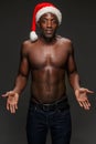Muscular black shirtless young man in Santa Claus hat Royalty Free Stock Photo