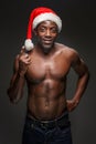 Muscular black shirtless young man in Santa Claus hat Royalty Free Stock Photo