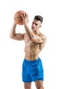 Muscular blond shirtless male model throwing basketball ball Royalty Free Stock Photo