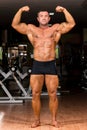 Muscular body builder showing his front double biceps Royalty Free Stock Photo