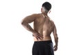 Muscular body sport man holding sore low back waist massaging with his hand suffering pain Royalty Free Stock Photo