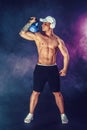 Muscular bodybuilder doing Exercise with kettlebell. Studio shot with smoke Royalty Free Stock Photo