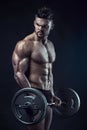 Muscular bodybuilder guy doing exercises with big dumbbell dumbb Royalty Free Stock Photo