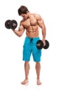 Muscular bodybuilder guy doing exercises with dumbbells