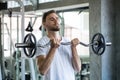 Muscular bodybuilder guy doing exercises with weight lifting barbell  in gym . sport young fitness man training .work out healthy Royalty Free Stock Photo