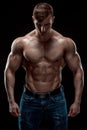 Muscular bodybuilder guy doing posing over black background Royalty Free Stock Photo