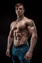 Muscular bodybuilder guy doing posing over black background Royalty Free Stock Photo