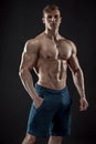 Muscular bodybuilder guy doing posing over black background Royalty Free Stock Photo