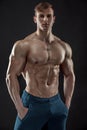 Muscular bodybuilder guy doing posing over black background Royalty Free Stock Photo