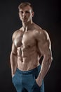 Muscular bodybuilder guy doing posing over black background Royalty Free Stock Photo