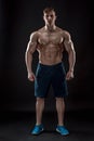 Muscular bodybuilder guy doing posing over black background Royalty Free Stock Photo