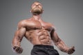 Muscular bodybuilder guy over dark background