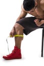 Muscular bodybuilder man measuring calf with tape measure Royalty Free Stock Photo