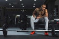 Muscular bodybuilder rest after deadlifts at gym