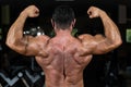 Muscular bodybuilder showing his back double biceps Royalty Free Stock Photo