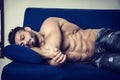 Muscular bodybuilder sleeping on couch Royalty Free Stock Photo