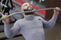 Muscular bodybuilder training in the gym, doing pulldown exercises for muscles