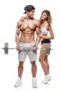 Muscular bodybuilder with woman doing exercises with dumbbells Royalty Free Stock Photo