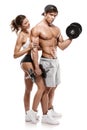 Muscular bodybuilder with woman doing exercises with dumbbells