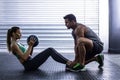 Muscular couple doing abdominal ball exercise