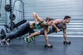 Muscular couple doing plank exercise together Royalty Free Stock Photo