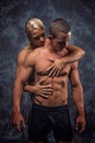 Muscular couple embracing