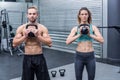 Muscular couple exercising with kettlebells Royalty Free Stock Photo