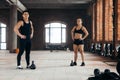 Muscular couple with hands on the hips looking at the camera during workout Royalty Free Stock Photo