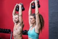 A muscular couple lifting kettlebells Royalty Free Stock Photo