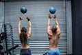 Muscular couple throwing ball in the air Royalty Free Stock Photo