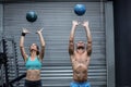 Muscular couple throwing ball in the air Royalty Free Stock Photo