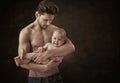 Muscular father carrying his cute son Royalty Free Stock Photo