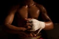 The muscular fighter tying tape around his hand Royalty Free Stock Photo