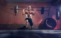 Muscular fitness man doing barbell lunges in his garage, selfiso Royalty Free Stock Photo