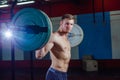 Muscular fitness man preparing to deadlift a barbell over his head in modern fitness center.Functional training.Snatch Royalty Free Stock Photo