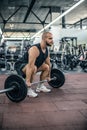 Muscular fitness man preparing to deadlift a barbell over his head in modern fitness center.Functional training.Snatch exercise Royalty Free Stock Photo