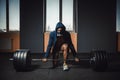 Athletic man in jacket with a hood waiting and preparing before lifting heavy barbell looking at camera. fitness, sport, training, Royalty Free Stock Photo