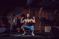 Muscular fitness man preparing to deadlift a barbell over his head in modern fitness center. Functional training. Royalty Free Stock Photo