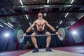 Muscular fitness man preparing to deadlift a barbell over his head in modern fitness center.Functional training.Snatch Royalty Free Stock Photo