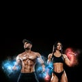 Muscular fitness sports man and fit woman, atletes with dumbbell in fitness gym. Energy and power. Ice and fire. Royalty Free Stock Photo