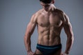 Muscular fitness young male antique perfect muscles six packs of abs and bare chest. Bodybuilder model trains with a stretching Royalty Free Stock Photo