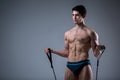 Muscular fitness young male antique perfect muscles six packs of abs and bare chest. Bodybuilder model trains with a stretching Royalty Free Stock Photo