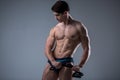 Muscular fitness young male antique perfect muscles six packs of abs and bare chest. Bodybuilder model trains with a stretching Royalty Free Stock Photo