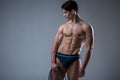 Muscular fitness young male antique perfect muscles six packs of abs and bare chest. Bodybuilder model trains with a stretching Royalty Free Stock Photo