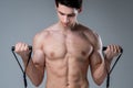 Muscular fitness young male antique perfect muscles six packs of abs and bare chest. Bodybuilder model trains with a stretching Royalty Free Stock Photo