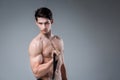 Muscular fitness young male antique perfect muscles six packs of abs and bare chest. Bodybuilder model trains with a stretching Royalty Free Stock Photo