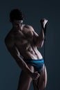 Muscular fitness young male antique perfect muscles six packs of abs and bare chest. Bodybuilder model trains with a stretching Royalty Free Stock Photo