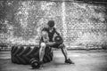 Muscular guy doing exercises with dumbbell against a brick wall Royalty Free Stock Photo