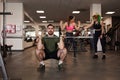 Muscular man doing weighted squats during group workout