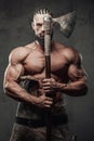 Muscular guy dressed like viking posing in dark background Royalty Free Stock Photo